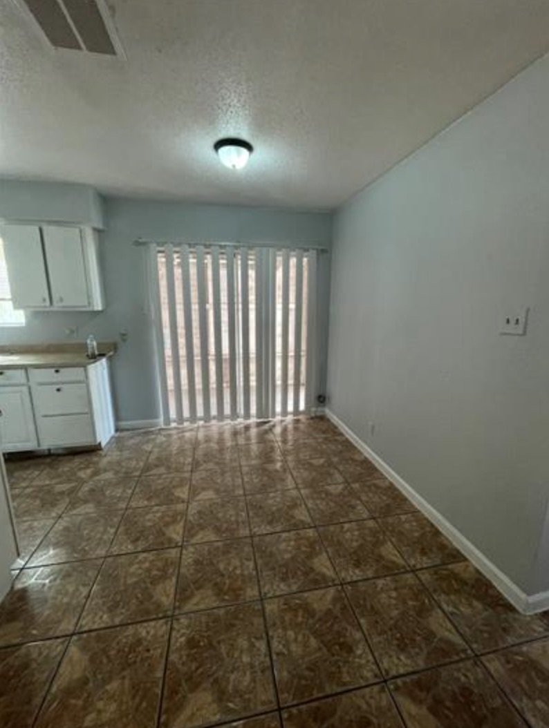 105 Cockerham Street, Unit A Kyle, TX 78640 - Photo 5 of 9 a view of an empty room with a window