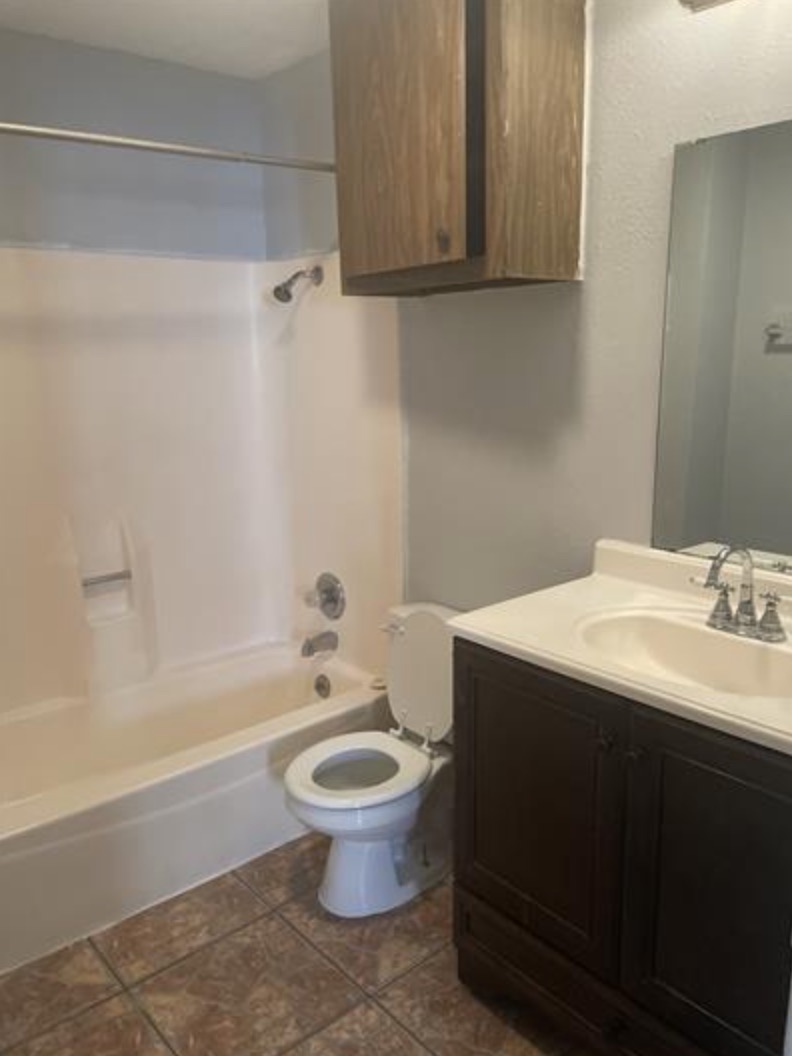 105 Cockerham Street, Unit A Kyle, TX 78640 - Photo 9 of 9 a bathroom with a sink a toilet and bathtub