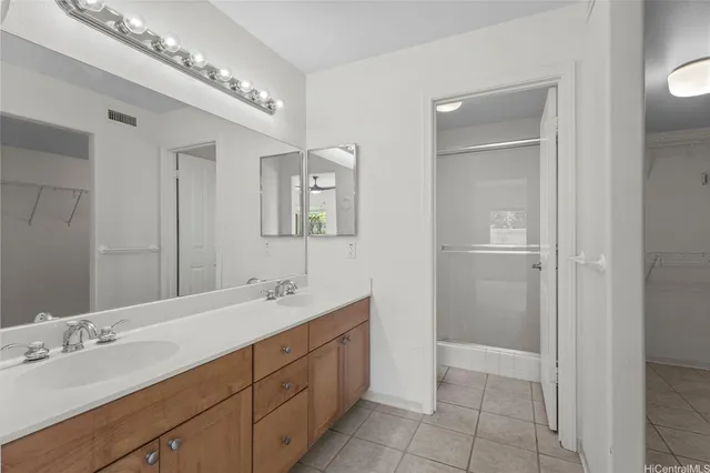 a spacious bathroom with a double vanity sink and a mirror