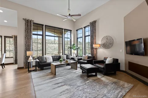 a living room with furniture large window and a flat screen tv