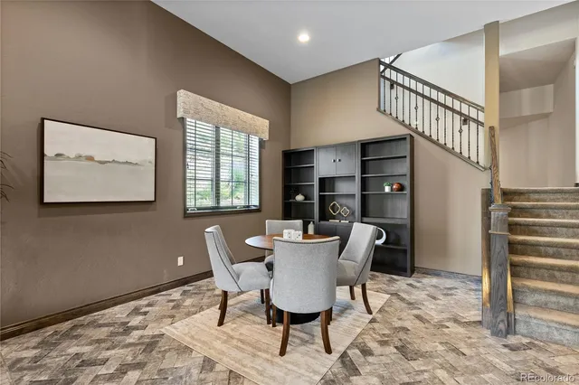 a view of a livingroom with furniture and staircase