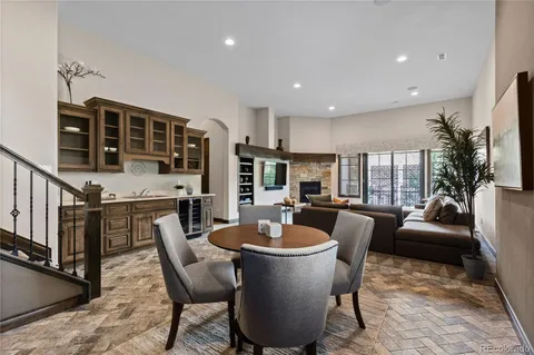 a dining room with furniture a rug and wooden floor