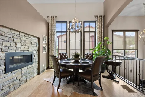 a dining room with furniture a flat screen tv and a chandelier