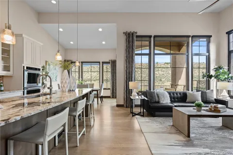 a living room with furniture wooden floor and a large window