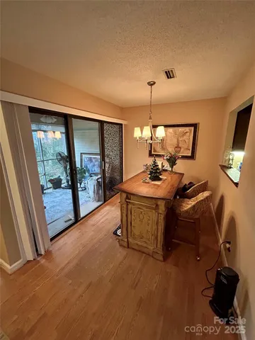 a dining room with furniture and a floor to ceiling window