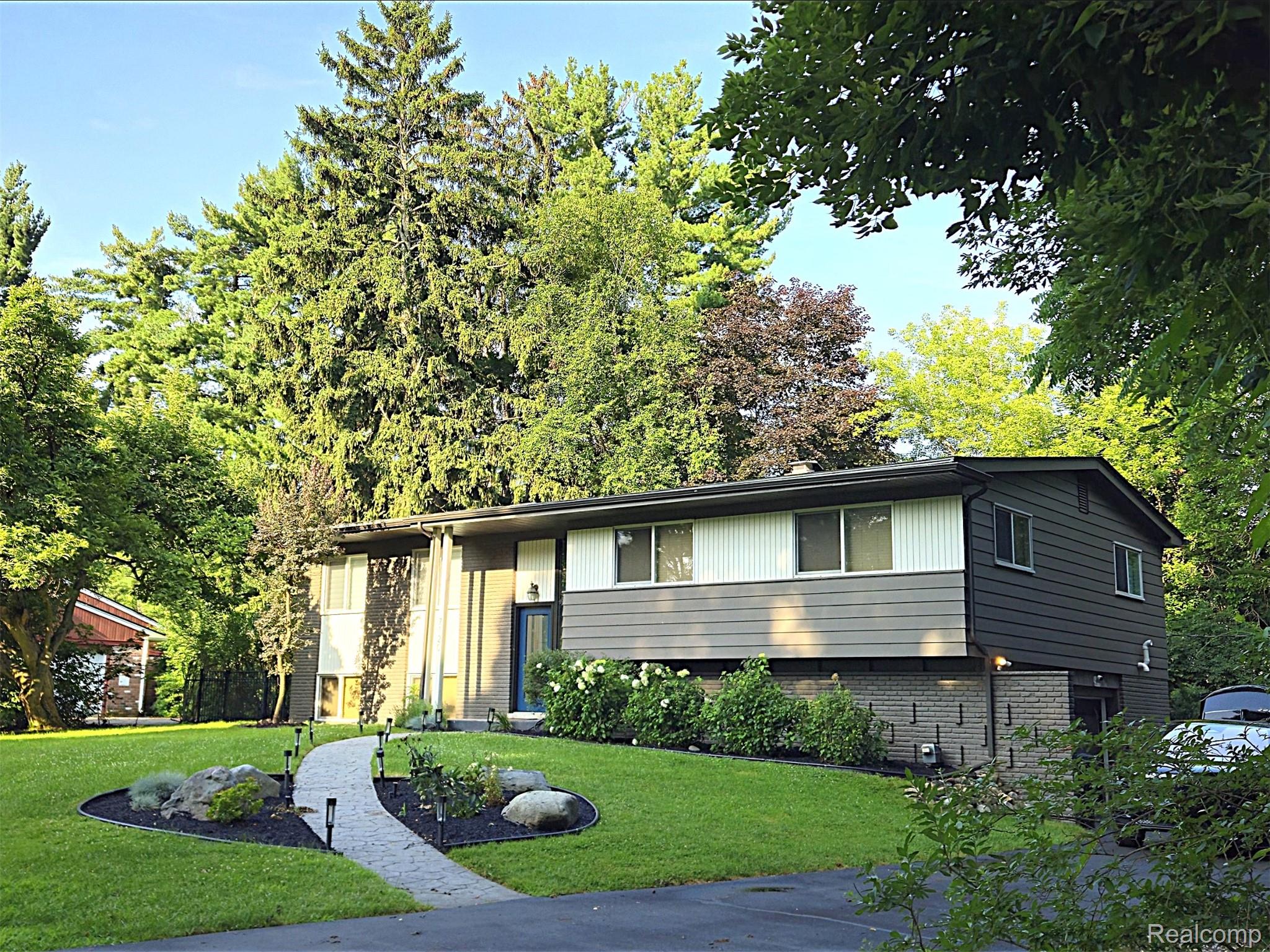7120 Pebblecreek Road West Bloomfield, MI 48322 - Photo 1 of 31 Split-level architectural style featuring a multi-toned facade with vertical and horizontal siding