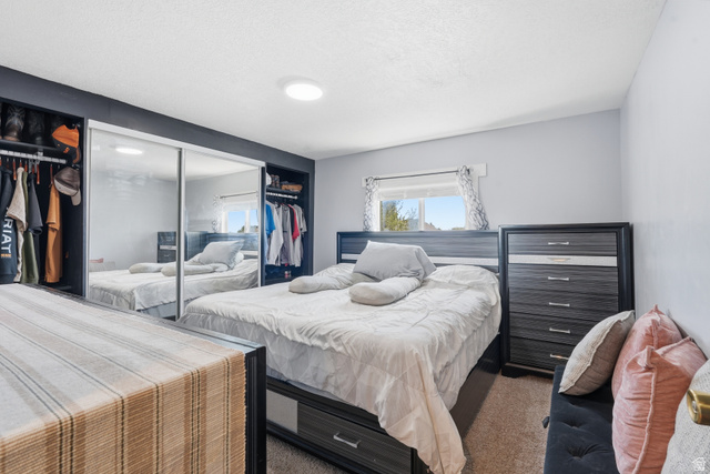 2500 North Fort Lane, Unit 220 Layton, UT 84041 - Photo 10 of 23 Bedroom featuring a window, recessed lighting, and built-in closet storage with mirrored sliding doors