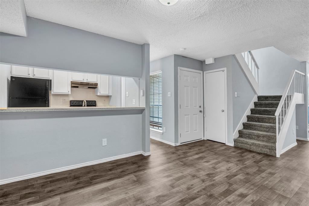 11311 Audelia Road, Unit 270 Dallas, TX 75243 - Photo 1 of 1 Kitchen with white cabinets and pass through bar area
