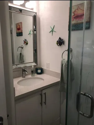 a white toilet sitting next to a bathroom sink