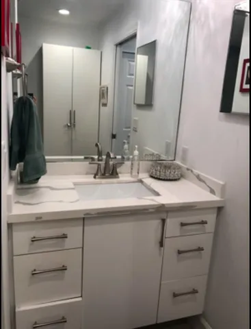 a bed sitting in a bedroom next to a lamp