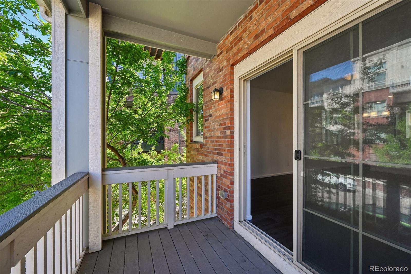 9520 Halstead Lane Lone Tree, CO 80124 - Photo 12 of 29 a view of a balcony with floor to ceiling window wooden floor and wooden fence