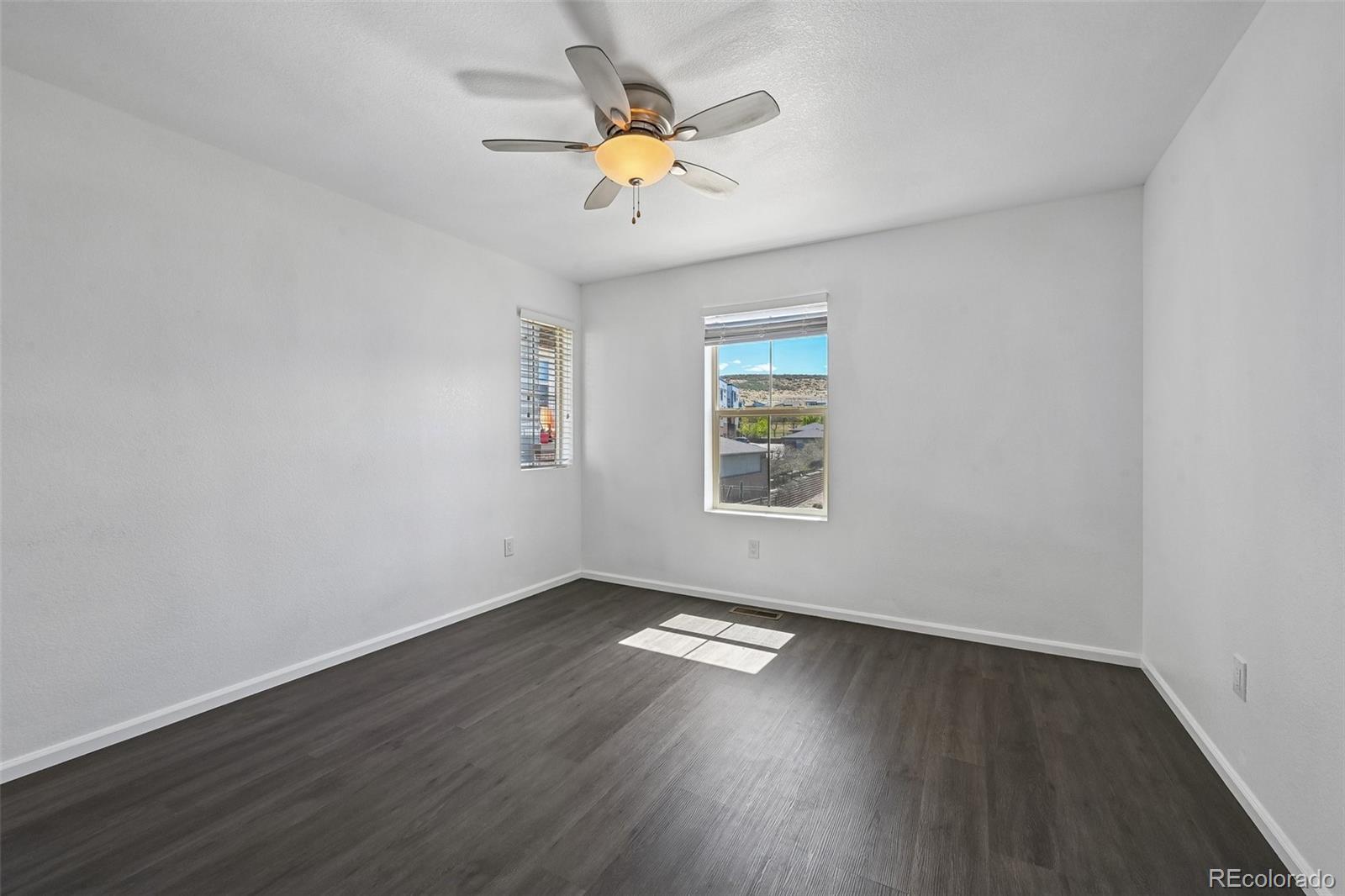 9520 Halstead Lane Lone Tree, CO 80124 - Photo 13 of 29 an empty room with wooden floor and windows