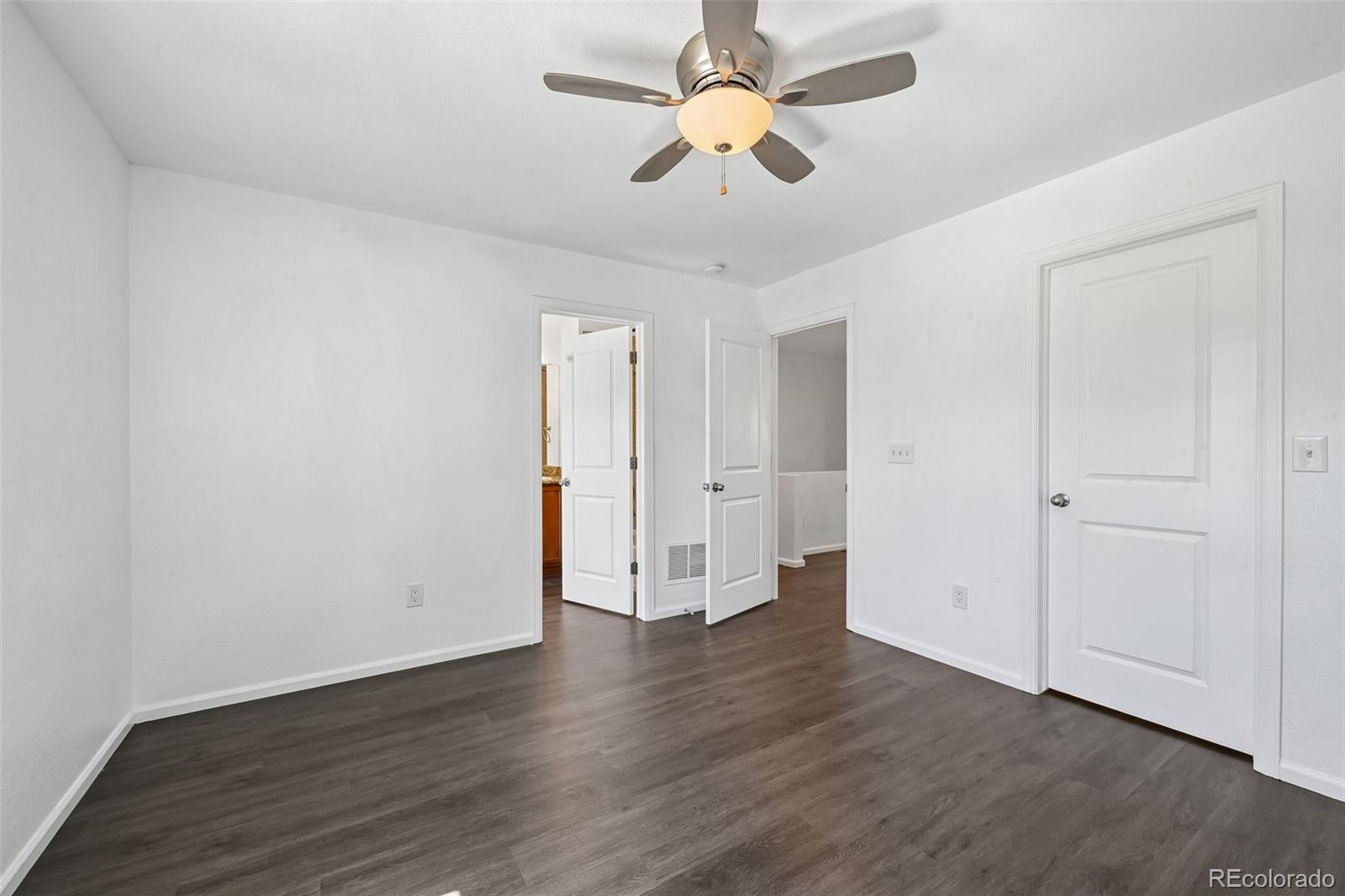 9520 Halstead Lane Lone Tree, CO 80124 - Photo 15 of 29 an empty room with wooden floor and ceiling fan