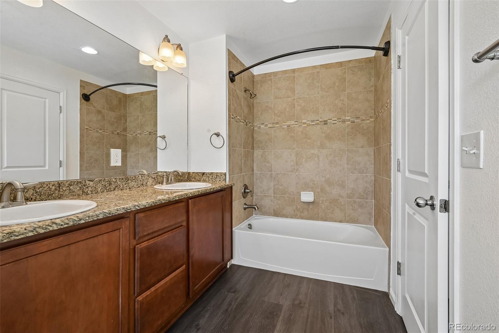 9520 Halstead Lane Lone Tree, CO 80124 - Photo 18 of 29 a bathroom with a granite countertop bathtub shower sink and mirror