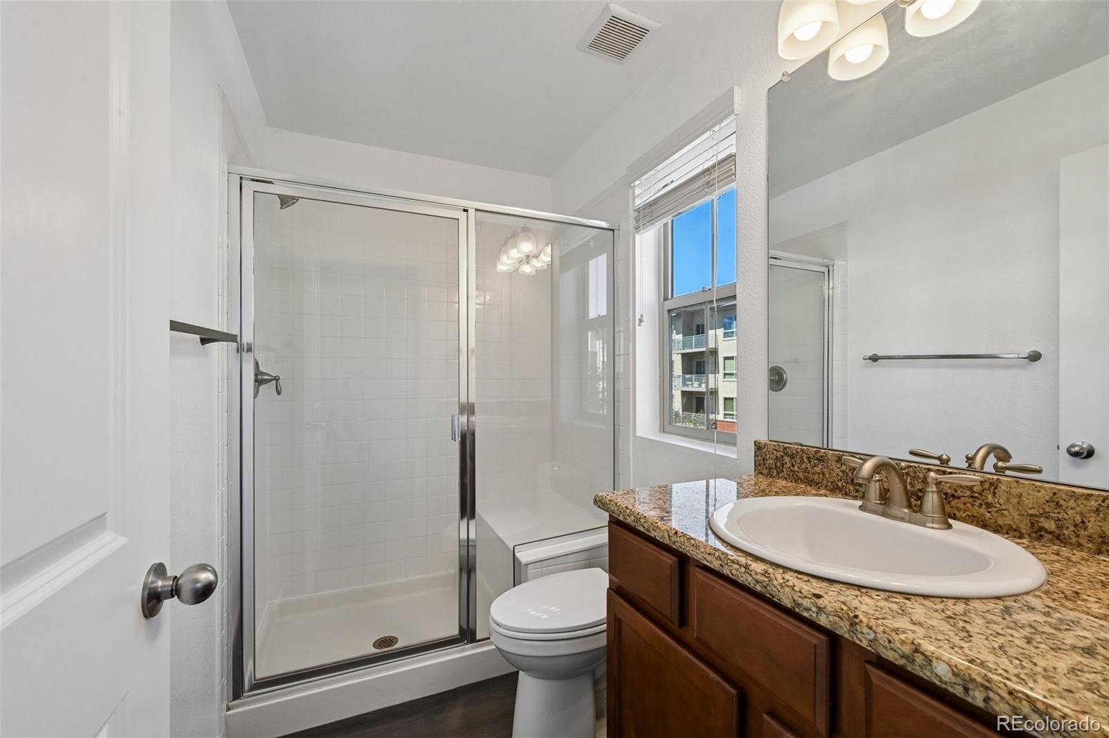 9520 Halstead Lane Lone Tree, CO 80124 - Photo 21 of 29 a bathroom with a granite countertop sink toilet and shower