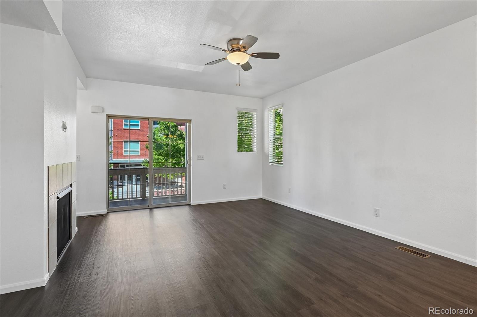 9520 Halstead Lane Lone Tree, CO 80124 - Photo 8 of 29 an empty room with wooden floor fan and windows