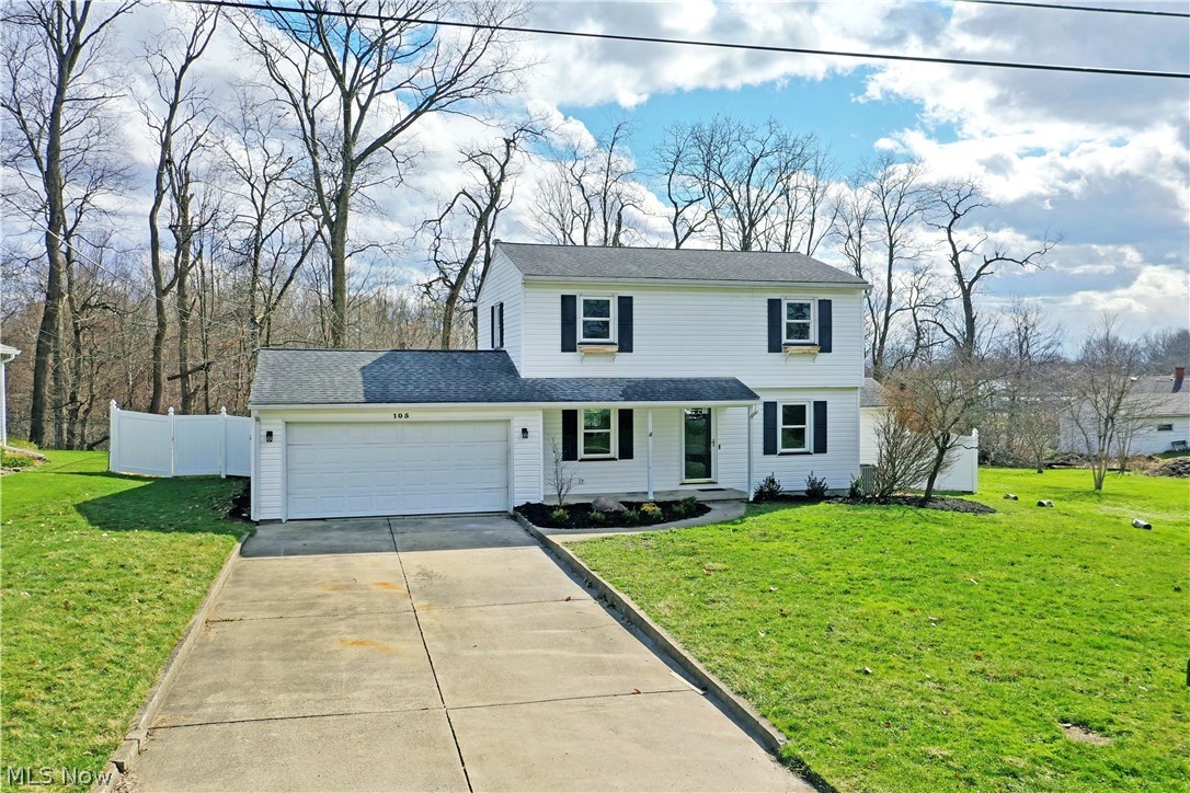 105 Fairview Avenue Cortland, OH 44410 - Photo 2 of 47 View of front of house with an attached garage, concrete driveway, and covered porch