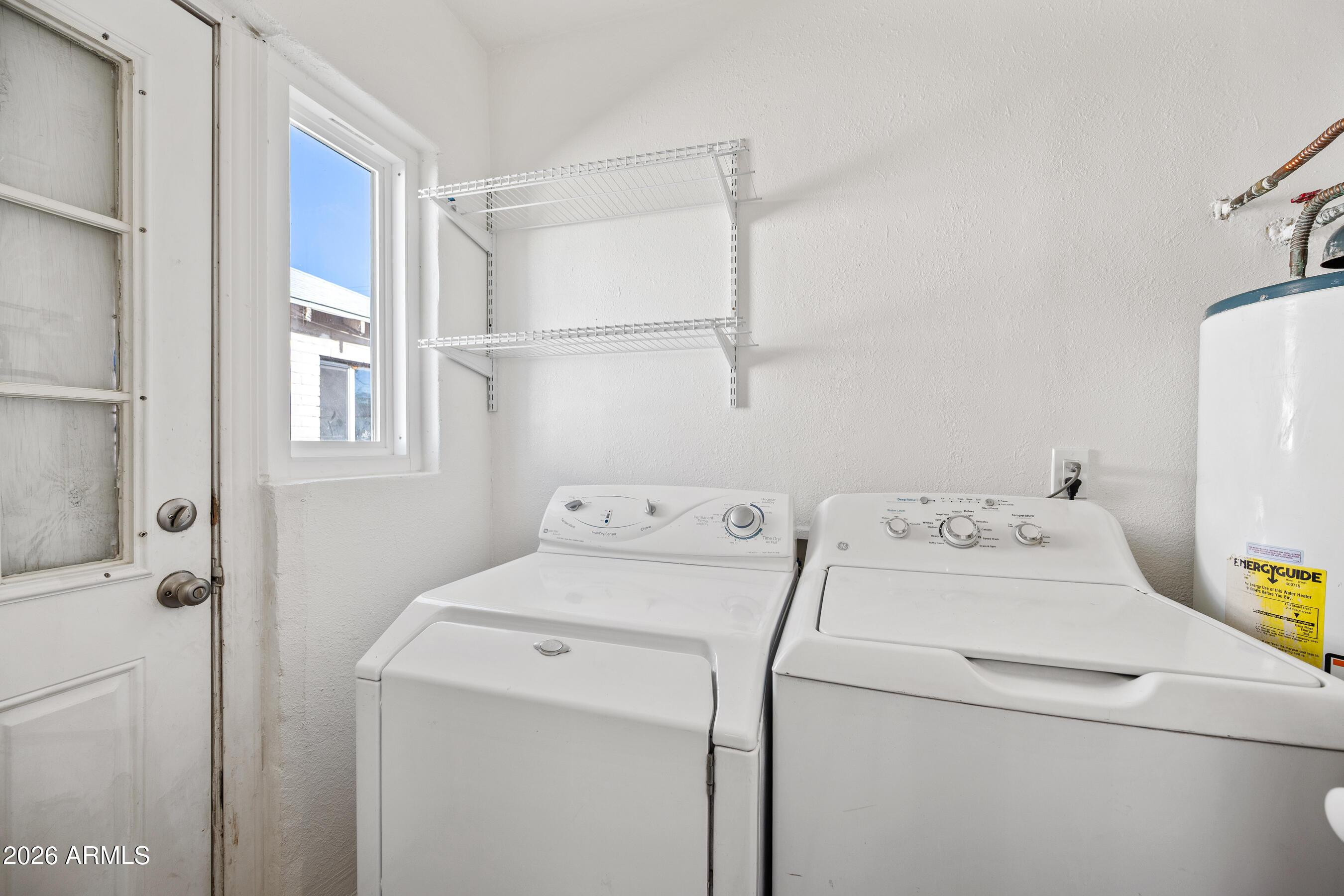 3903 North 12th Street Phoenix, AZ 85014 - Photo 14 of 16 a view of storage and utility room with washer and dryer