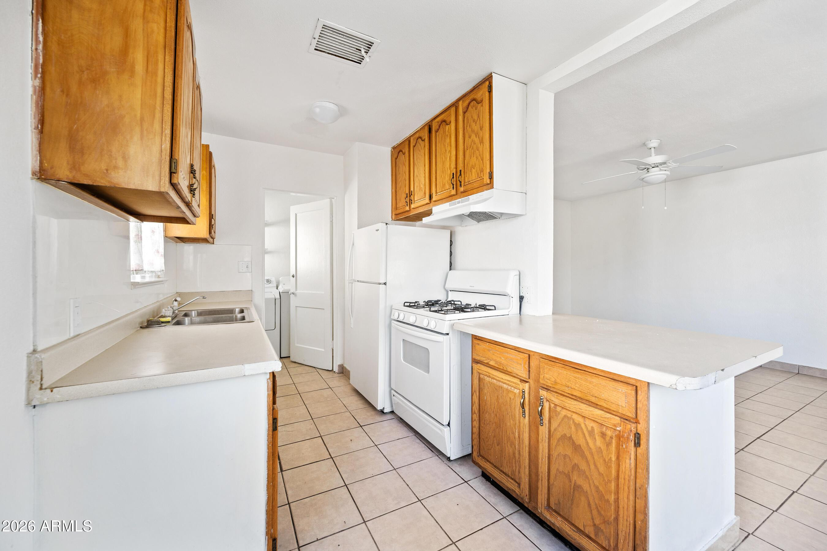 3903 North 12th Street Phoenix, AZ 85014 - Photo 6 of 16 a kitchen with a sink cabinets and appliances