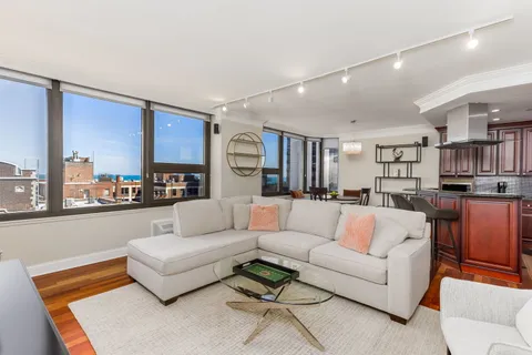 a living room with furniture and kitchen view