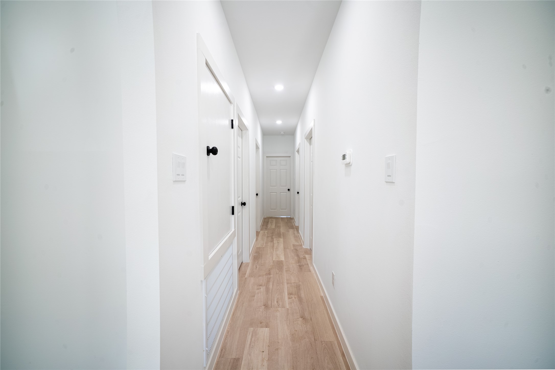 331 Delaware Street Houston, TX 77029 - Photo 6 of 12 a view of a hallway with wooden floor