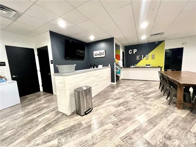 a living room with a flat screen tv and a table