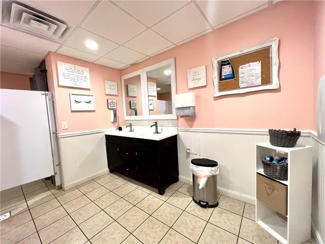 a bathroom with a sink a toilet and a mirror