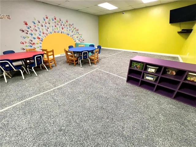 a view of a room with table and chairs