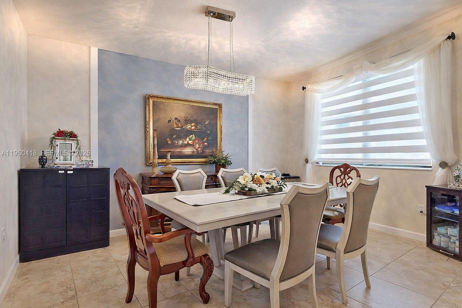 132 Northeast 26th Avenue Homestead, FL 33033 - Photo 14 of 68 a dining room with furniture a chandelier and window
