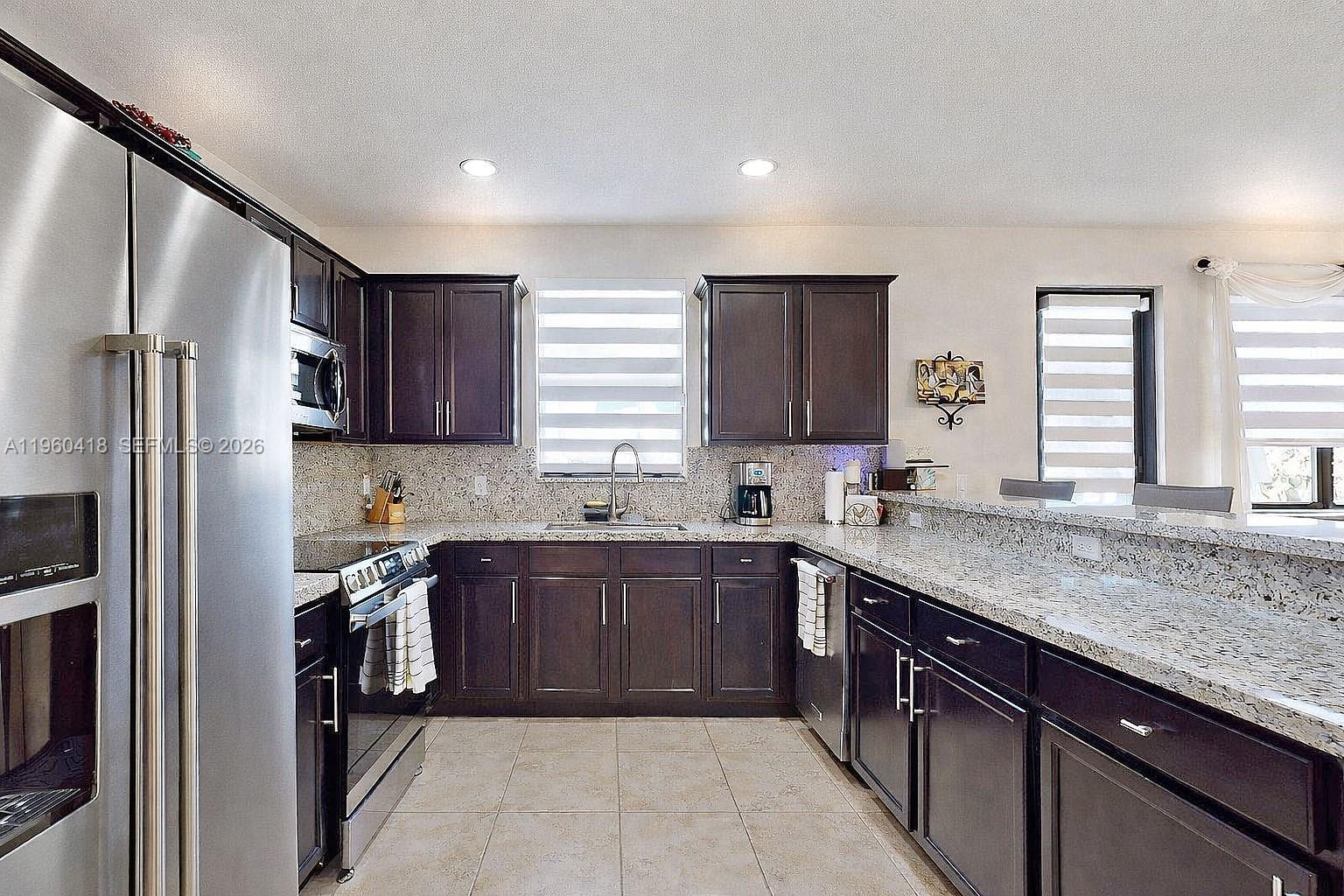 132 Northeast 26th Avenue Homestead, FL 33033 - Photo 16 of 68 a kitchen with a sink a window and stainless steel appliances