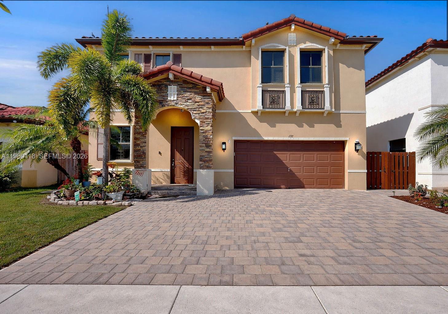 132 Northeast 26th Avenue Homestead, FL 33033 - Photo 2 of 68 a front view of a house with a yard