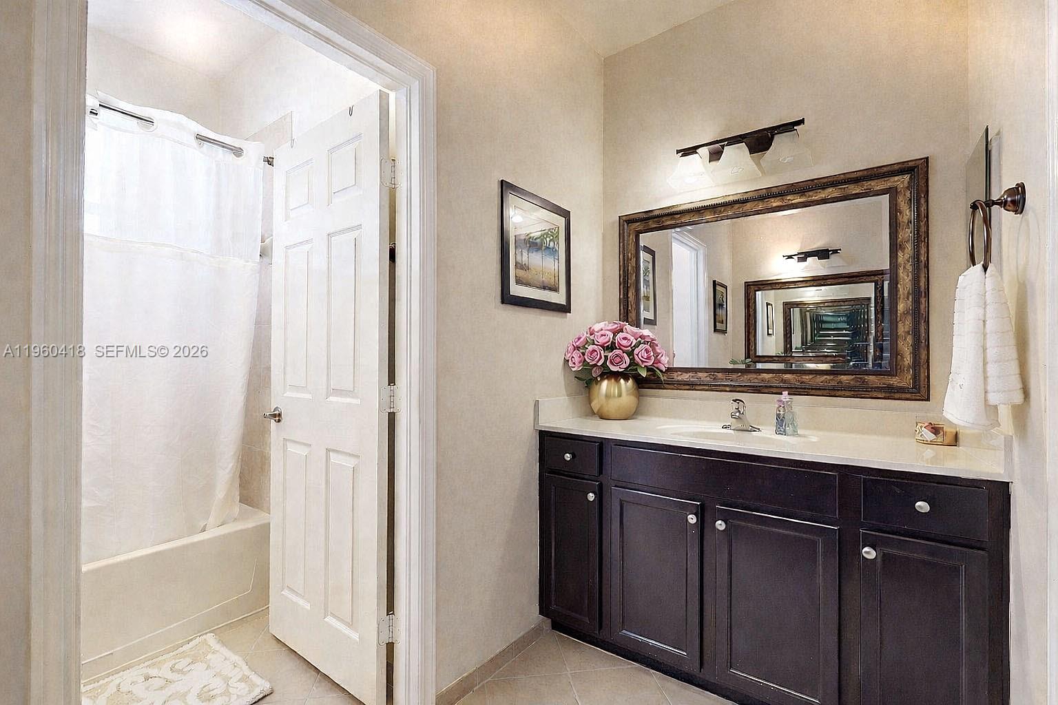 132 Northeast 26th Avenue Homestead, FL 33033 - Photo 41 of 68 a bathroom with a bathtub a sink and a mirror