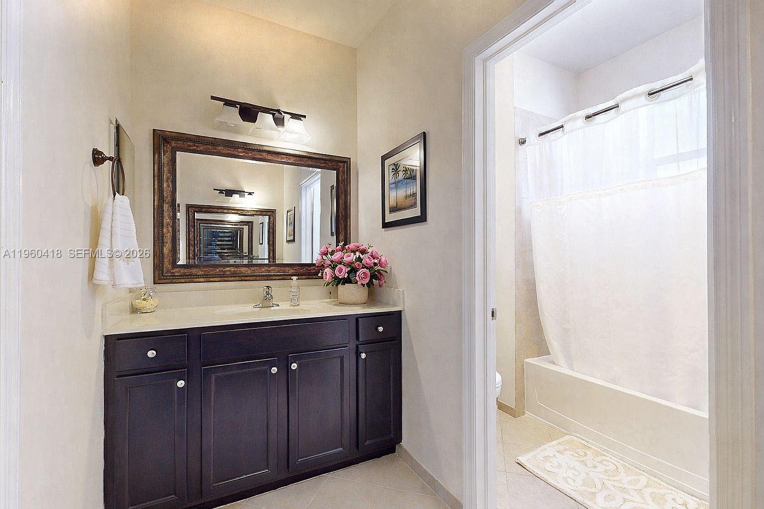 132 Northeast 26th Avenue Homestead, FL 33033 - Photo 42 of 68 a bathroom with a granite countertop sink mirror and a bathtub