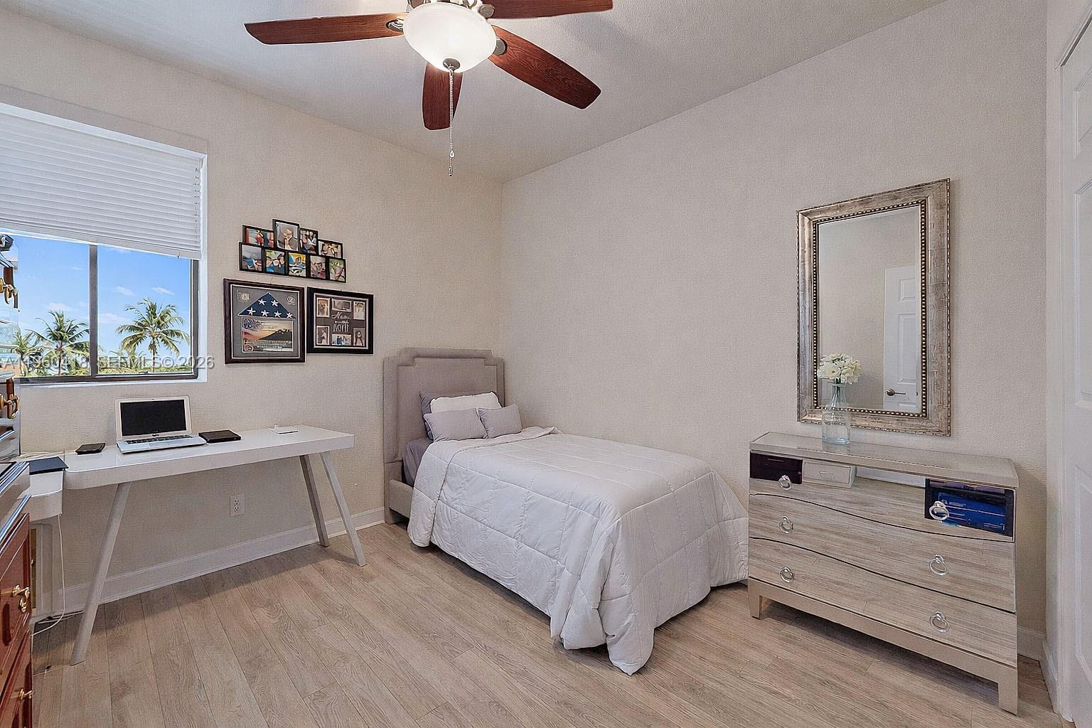 132 Northeast 26th Avenue Homestead, FL 33033 - Photo 46 of 68 a bedroom with a large bed and a chandelier