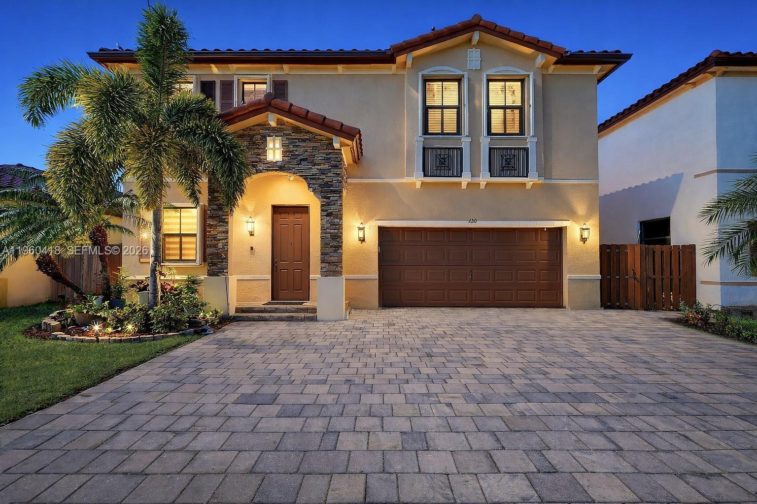 132 Northeast 26th Avenue Homestead, FL 33033 - Photo 57 of 68 a front view of a house with a yard and garage