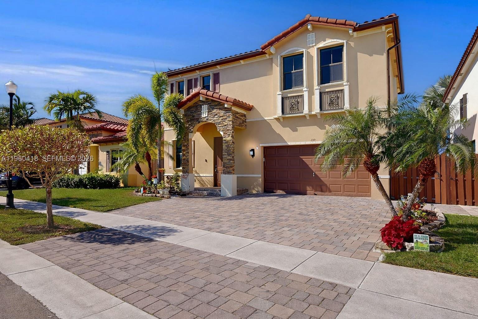132 Northeast 26th Avenue Homestead, FL 33033 - Photo 58 of 68 a front view of a house with a yard and potted plants
