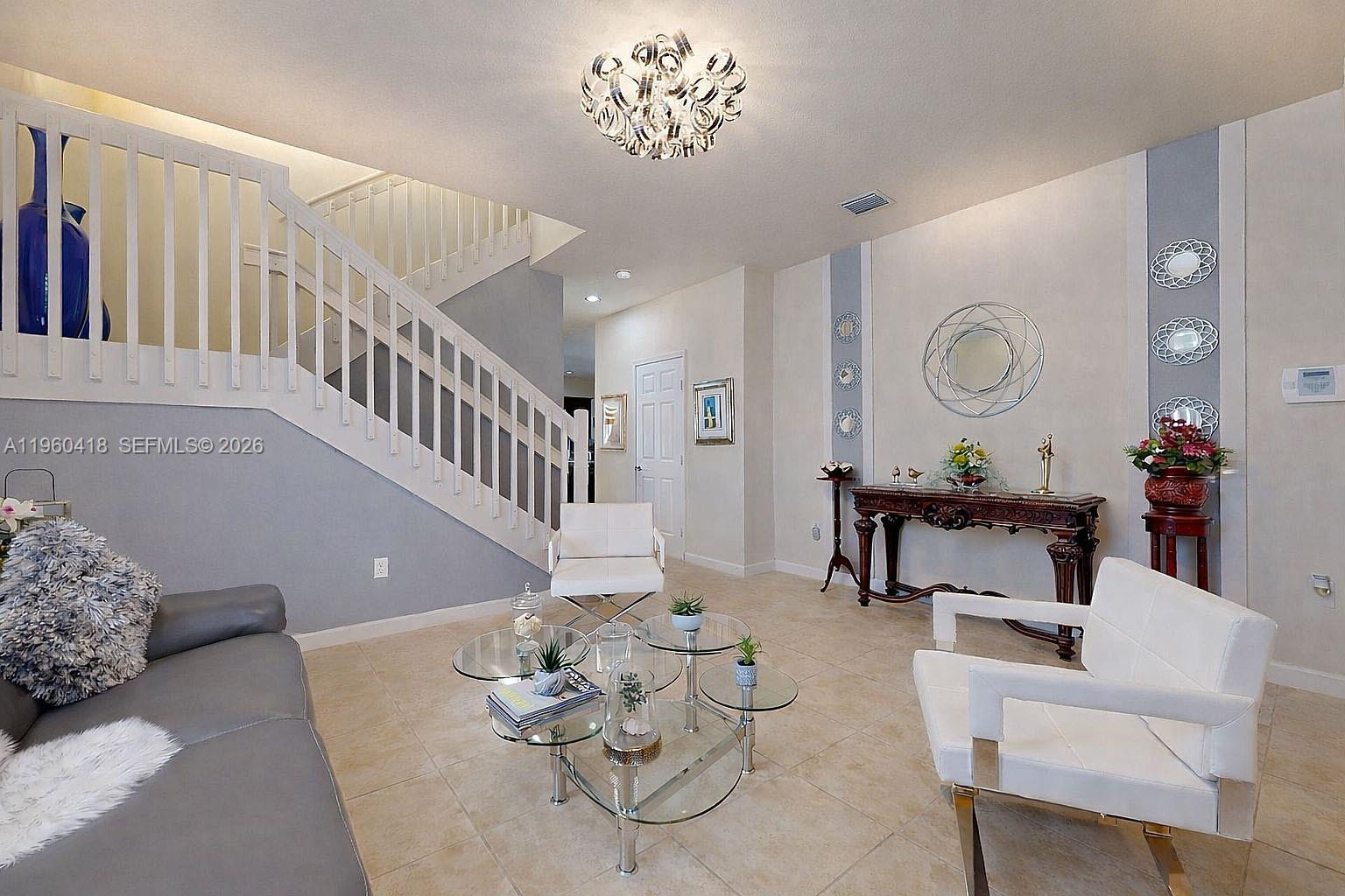 132 Northeast 26th Avenue Homestead, FL 33033 - Photo 10 of 68 a living room with furniture and a large window