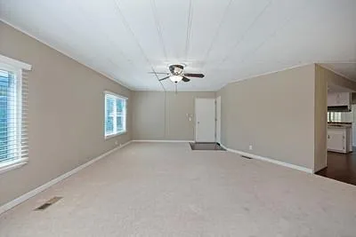 a kitchen with granite countertop white cabinets and stainless steel appliances