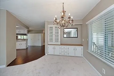 a kitchen with stainless steel appliances a refrigerator and wooden floor