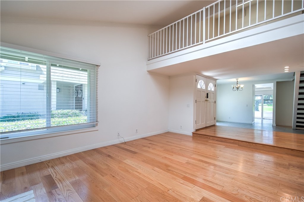 13 Brookmont, Unit 60 Irvine, CA 92604 - Photo 14 of 49 a view of an empty room with wooden floor and a window