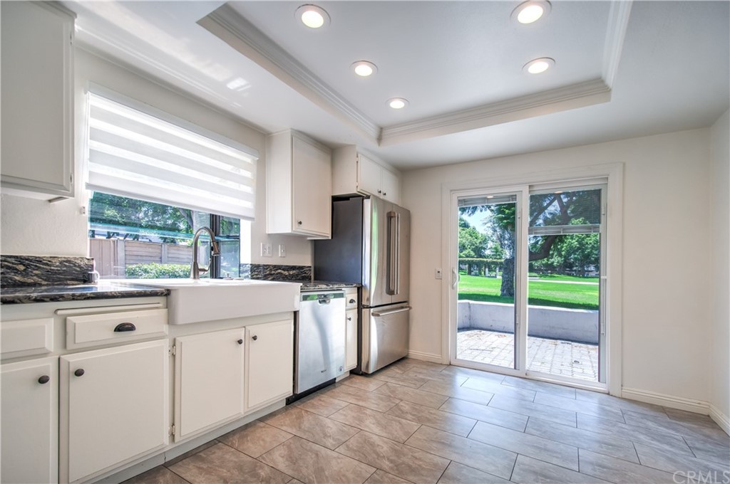 13 Brookmont, Unit 60 Irvine, CA 92604 - Photo 15 of 49 a kitchen with granite countertop a refrigerator oven a sink and a large window