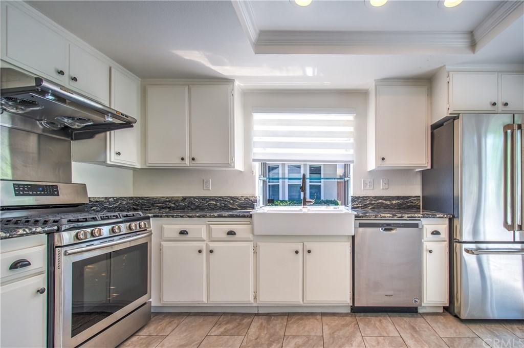 13 Brookmont, Unit 60 Irvine, CA 92604 - Photo 16 of 49 a kitchen with stainless steel appliances granite countertop a stove a refrigerator and a stove