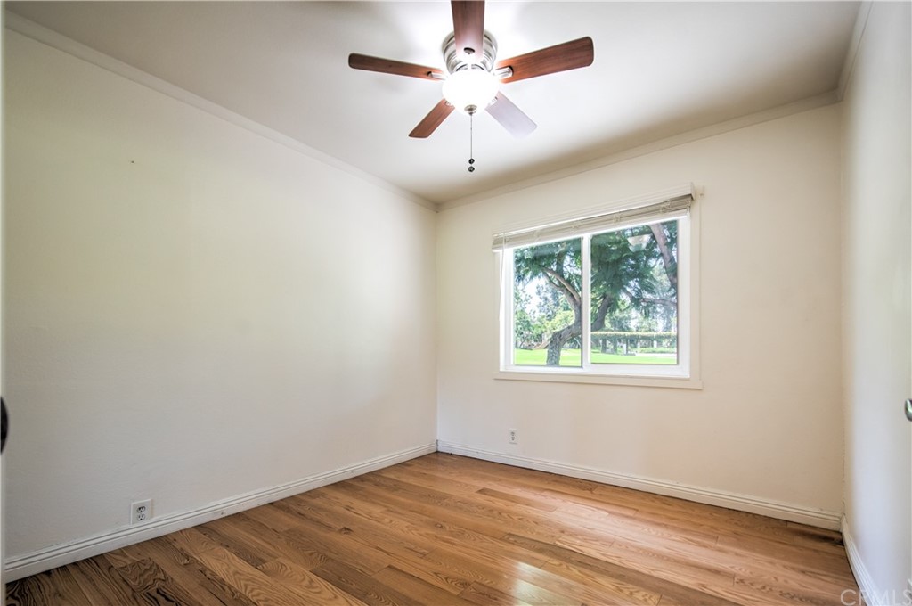 13 Brookmont, Unit 60 Irvine, CA 92604 - Photo 17 of 49 an empty room with wooden floor ceiling fan and windows