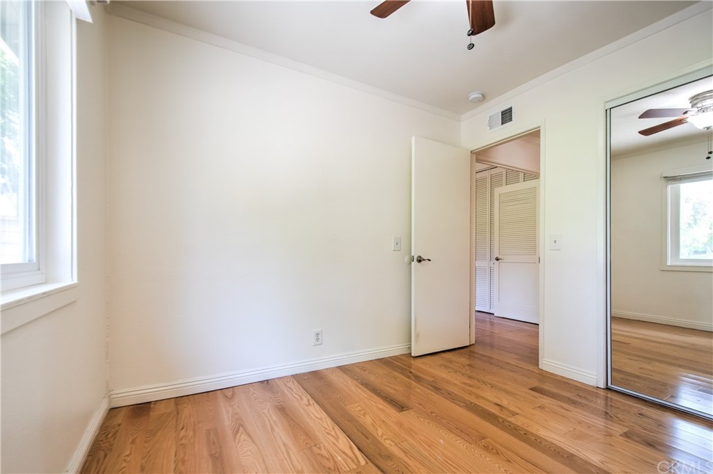13 Brookmont, Unit 60 Irvine, CA 92604 - Photo 18 of 49 a view of an empty room with wooden floor