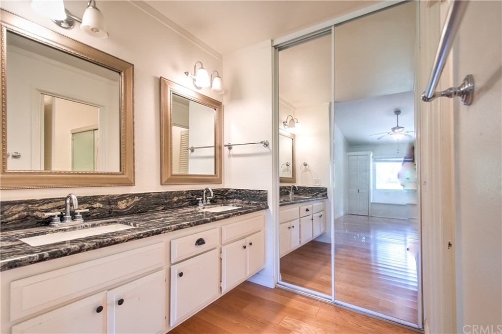 13 Brookmont, Unit 60 Irvine, CA 92604 - Photo 24 of 49 a bathroom with a granite countertop sink mirror and a