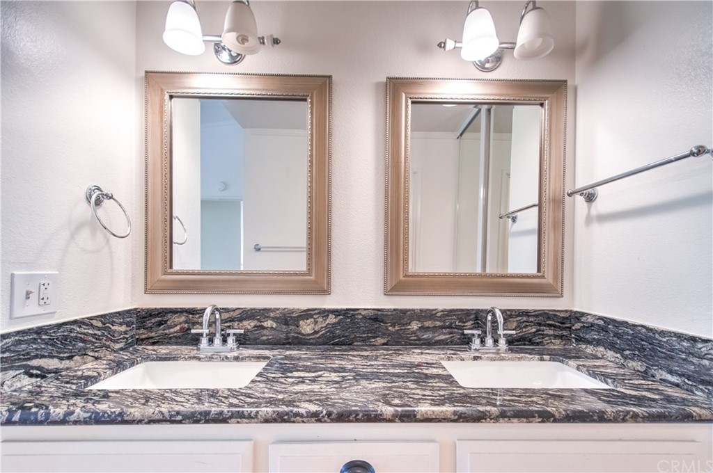 13 Brookmont, Unit 60 Irvine, CA 92604 - Photo 25 of 49 a bathroom with a granite countertop sink and a mirror