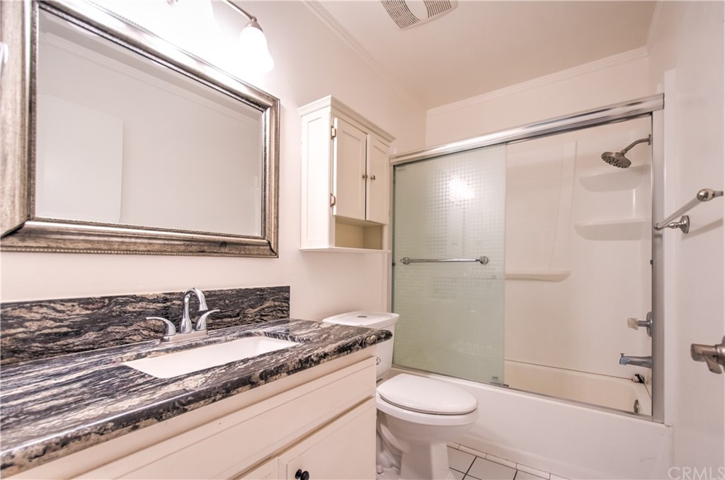 13 Brookmont, Unit 60 Irvine, CA 92604 - Photo 28 of 49 a bathroom with a granite countertop sink toilet and shower