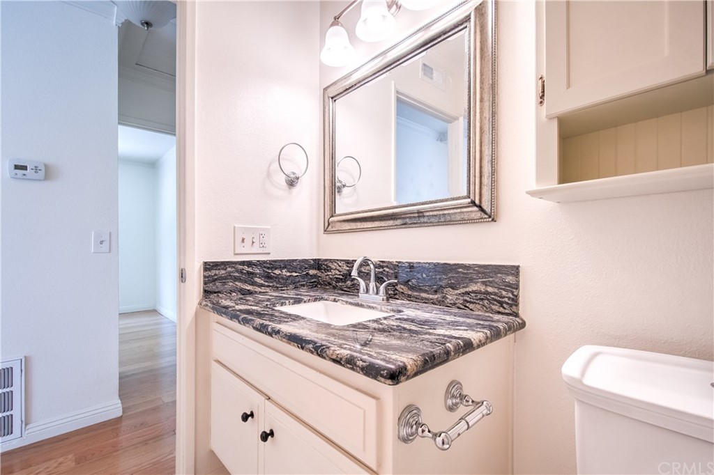 13 Brookmont, Unit 60 Irvine, CA 92604 - Photo 29 of 49 a bathroom with a granite countertop sink and a mirror