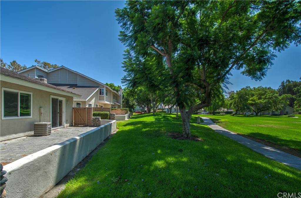 13 Brookmont, Unit 60 Irvine, CA 92604 - Photo 3 of 49 a view of a house with a big yard potted plants and large tree