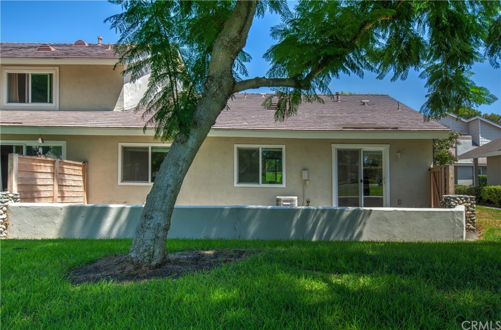13 Brookmont, Unit 60 Irvine, CA 92604 - Photo 35 of 49 a front view of a house with a garden and yard